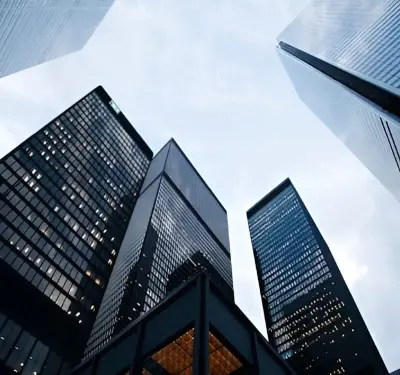 Looking up at modern glass office towers